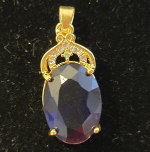 Gold-Toned Pendant with Deep Blue Faceted Oval Stone